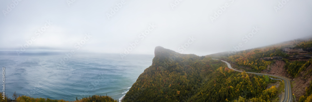 Aerial panoramic view of a Scenic Highway on the Atlantic Ocean Coast during a cloudy day. Taken in near Percé, Quebec, Canada.