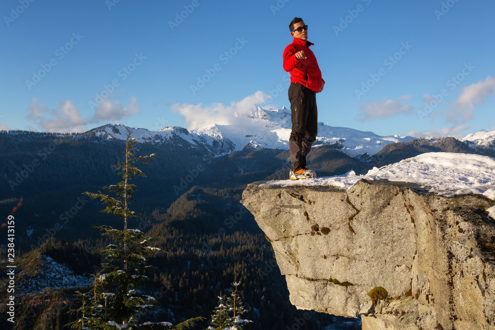 Adventurous Man enjoying the beautiful Canadian winter landscape during a bright sunny day. Taken on a hike to Watersprite Lake, near Squamish, North of Vancouver, BC, Canada. Adventurous Man enjoying the beautiful Canadian winter landscape during a bright sunny day. Taken on a hike to Watersprite Lake, near Squamish, North of Vancouver, BC, Canada.