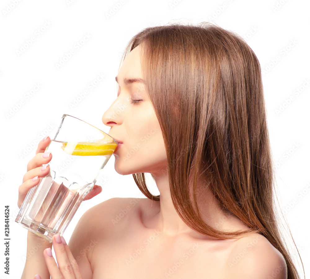 Beautiful woman a glass of water with lemon in hand health beauty on white background isolation Beautiful woman a glass of water with lemon in hand health beauty on white background isolation