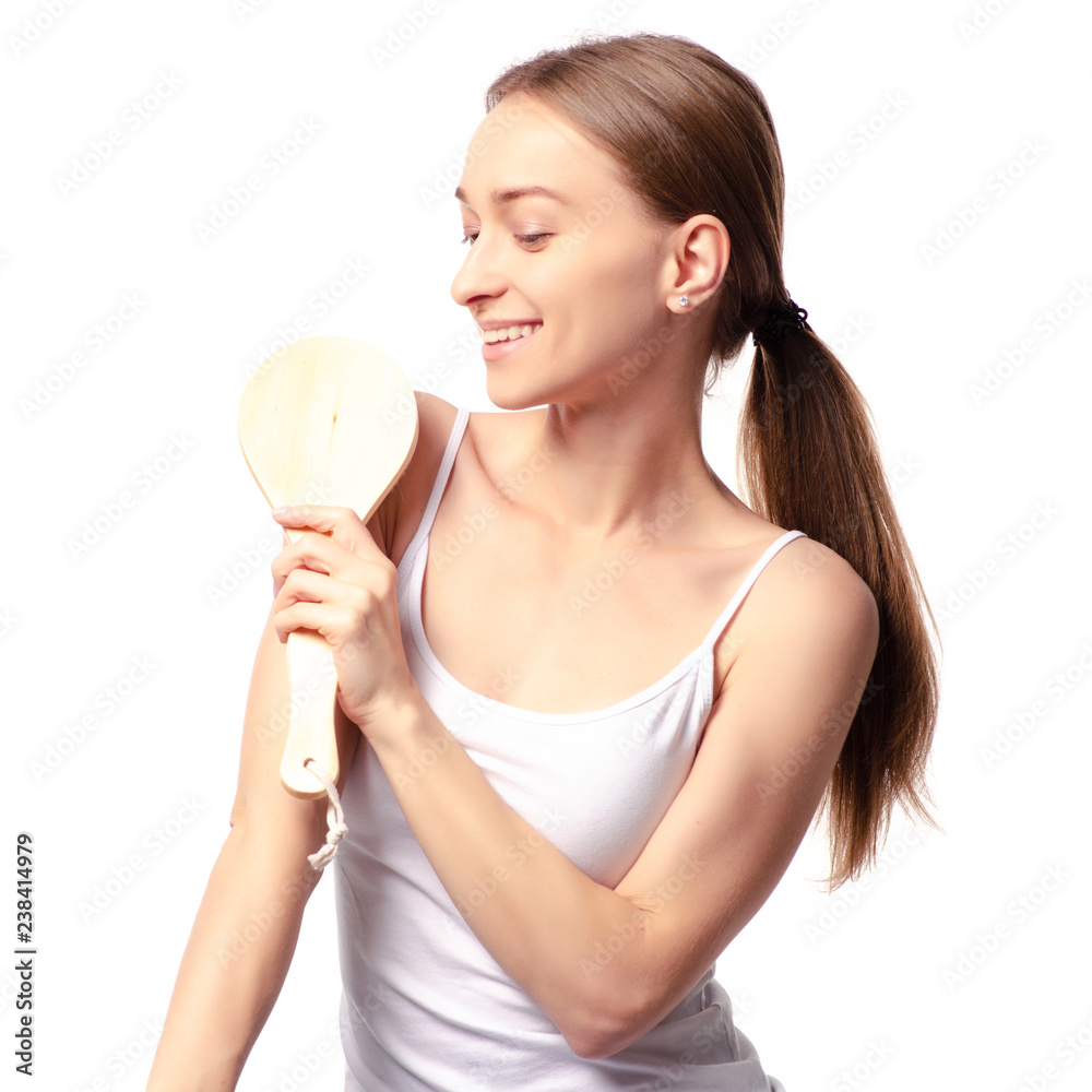 Beautiful woman brush from cellulite in hands on a white background. Isolation Beautiful woman brush from cellulite in hands on a white background. Isolation