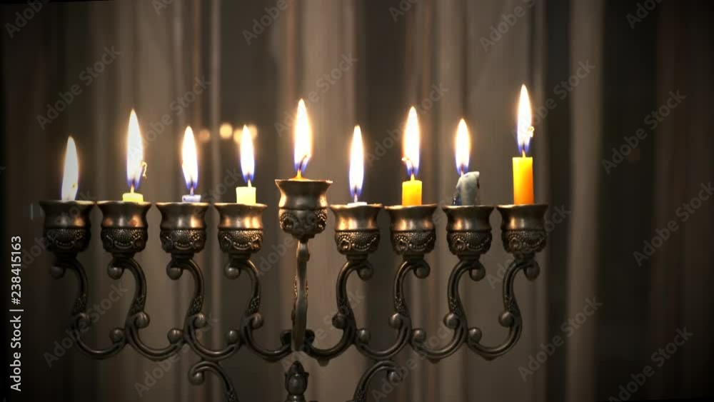 Last eighth day of the Jewish holiday Hanukkah. Nine Hanukkah candles are burning on light curtain background. 4k Last eighth day of the Jewish holiday Hanukkah. Nine Hanukkah candles are burning on light curtain background. 4k