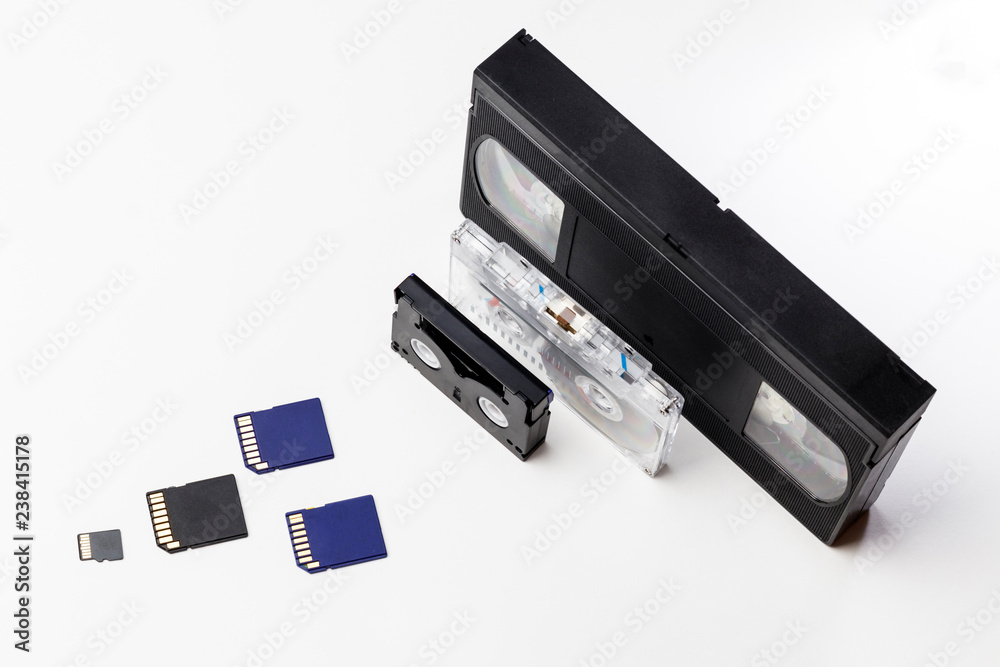The video is big and small. Memory card to record video. The concept of perfect video storage technology. on a white background. no isolation. there is toning The video is big and small. Memory card to record video. The concept of perfect video storage technology. on a white background. no isolation. there is toning