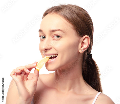 Beautiful woman with lemon beauty fashion skin freshness face  eats sour lemon on a white background. Isolation