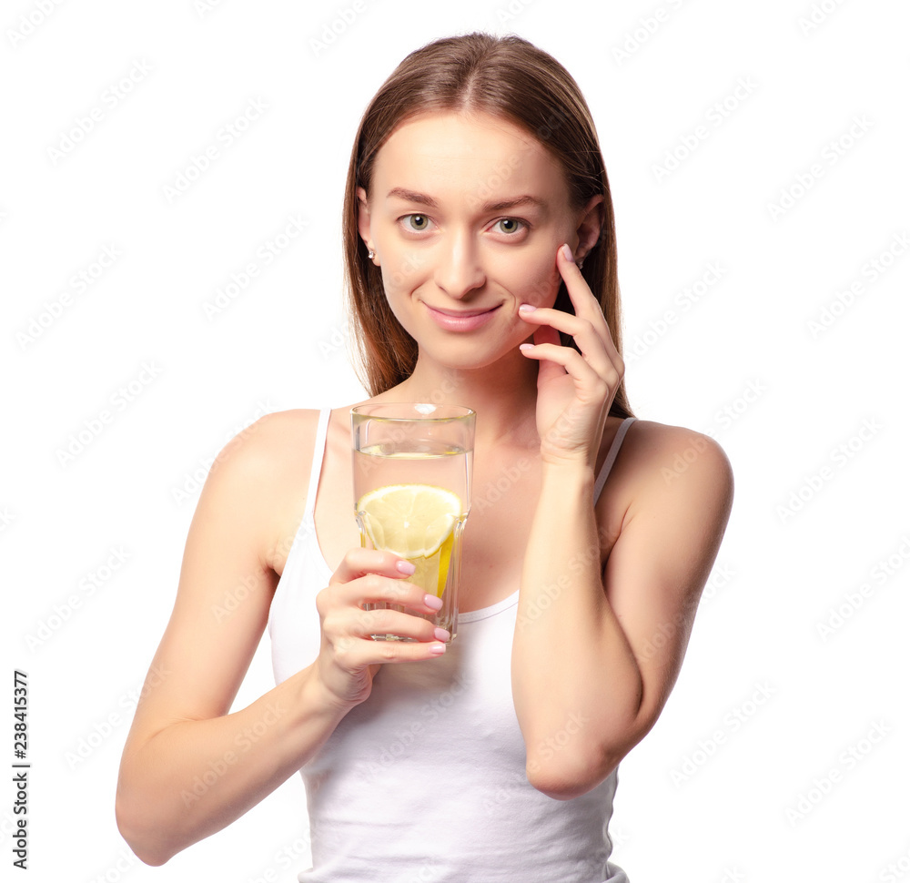 Beautiful woman a glass of water with lemon in hand health beauty on white background isolation Beautiful woman a glass of water with lemon in hand health beauty on white background isolation