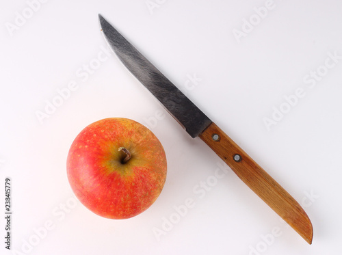 Red apple and knife on a white background photo