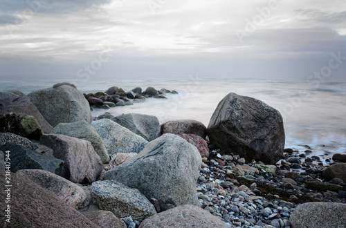 stones on the coast in the sea, soft waves by long time exposure, copy space © Maren Winter