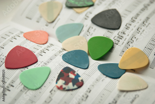 guitar picks on the notebook with notes