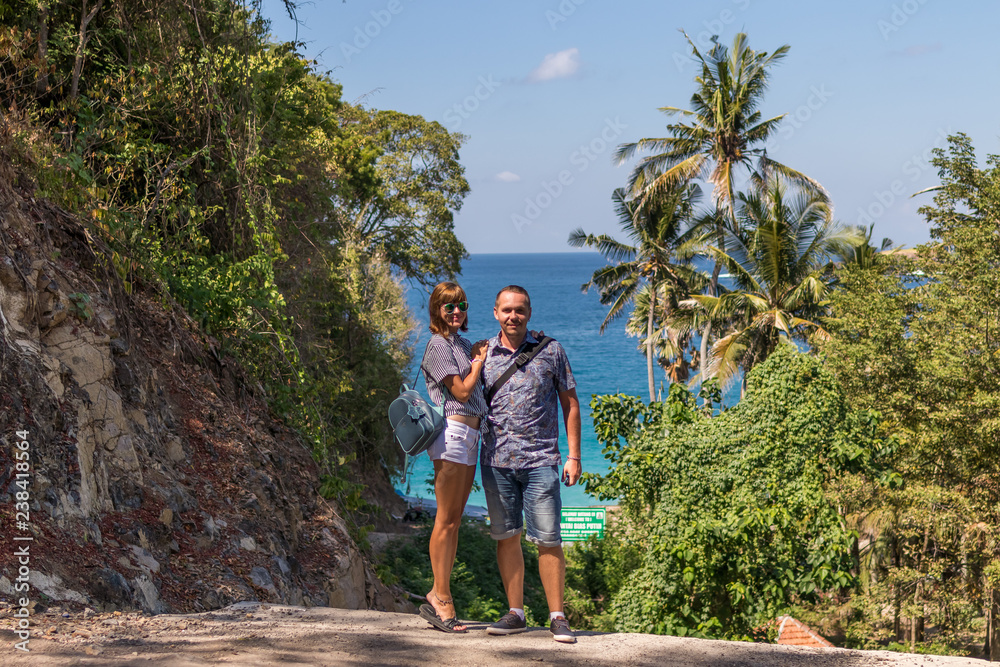 Young honeymoon couple on a beatiful tropical background. Bali island.