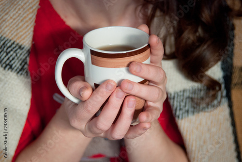 cup of hot tea in female hands