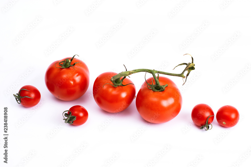Ripe tomatoes isolated on white background. The whole vegetables with sepals. Fresh tomatoes isolate Ripe tomatoes isolated on white background. The whole vegetables with sepals. Fresh tomatoes isolate