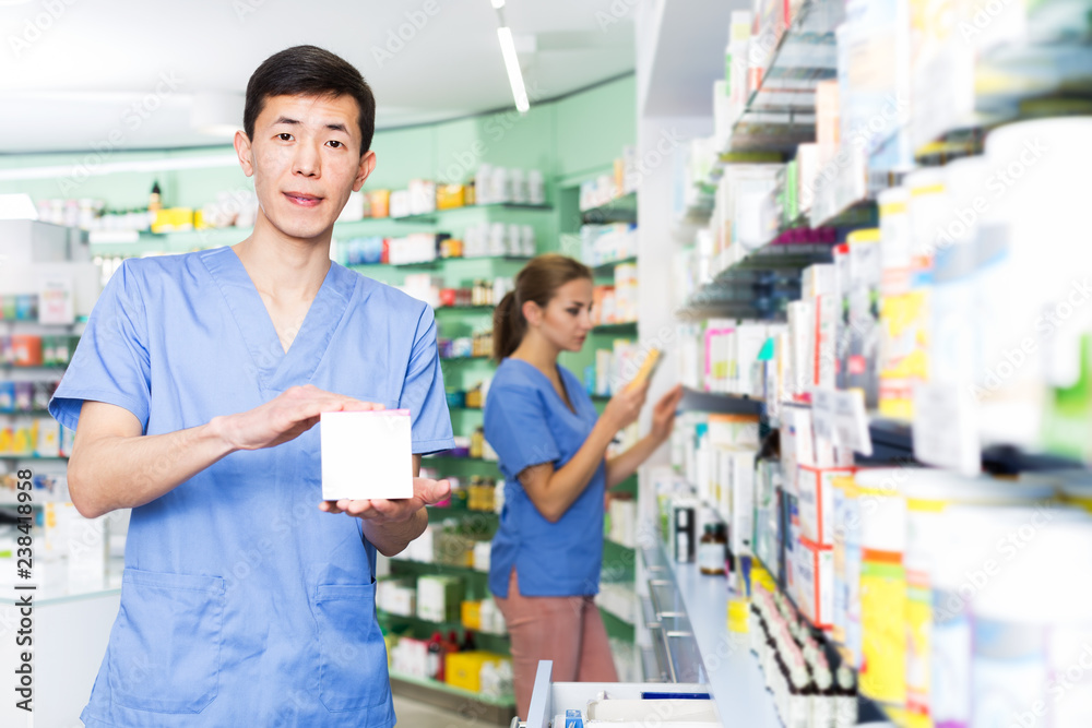 Pharmacist with medicines in pharmacy