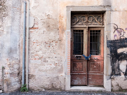 Old closed wooden door with chain and padlock