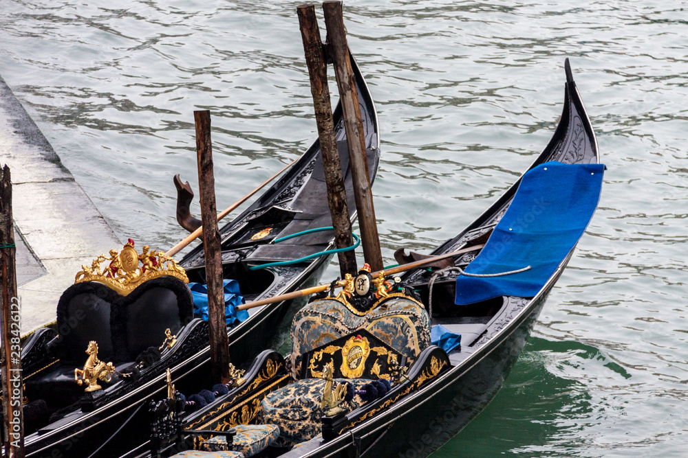  Two Gondola moored in a channel of Venice i