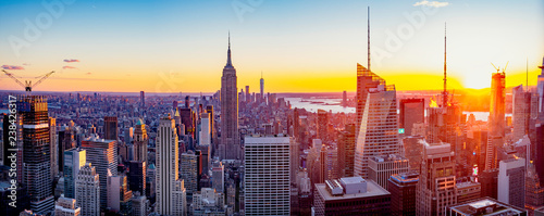 New York City / Manhattan skyline panorama with urban skyscrapers at sunset, USA.