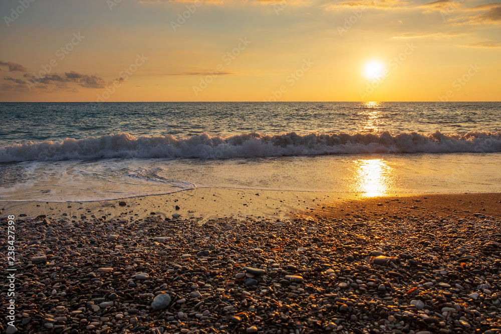 Beautiful sunset view of breaking waves at Petra tou Romiou (Aphrodite's birthplace) beach, in Paphos, Cyprus.