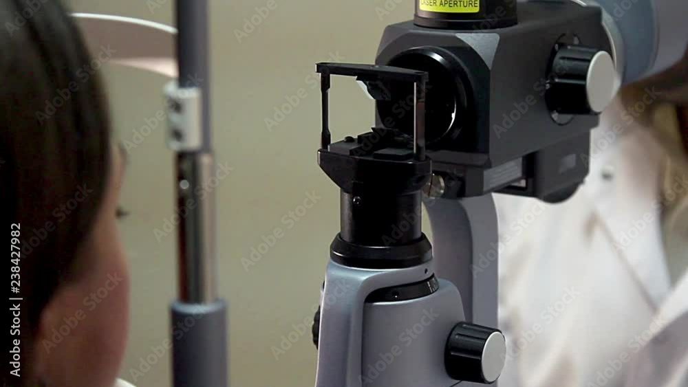 ophthalmologic test, Medical biomicroscope device laser shine inside eye, Optometrist examining female patient on phoropter in ophthalmology clinic, ophthalmologic test, Medical biomicroscope device laser shine inside eye, Optometrist examining female patient on phoropter in ophthalmology clinic,