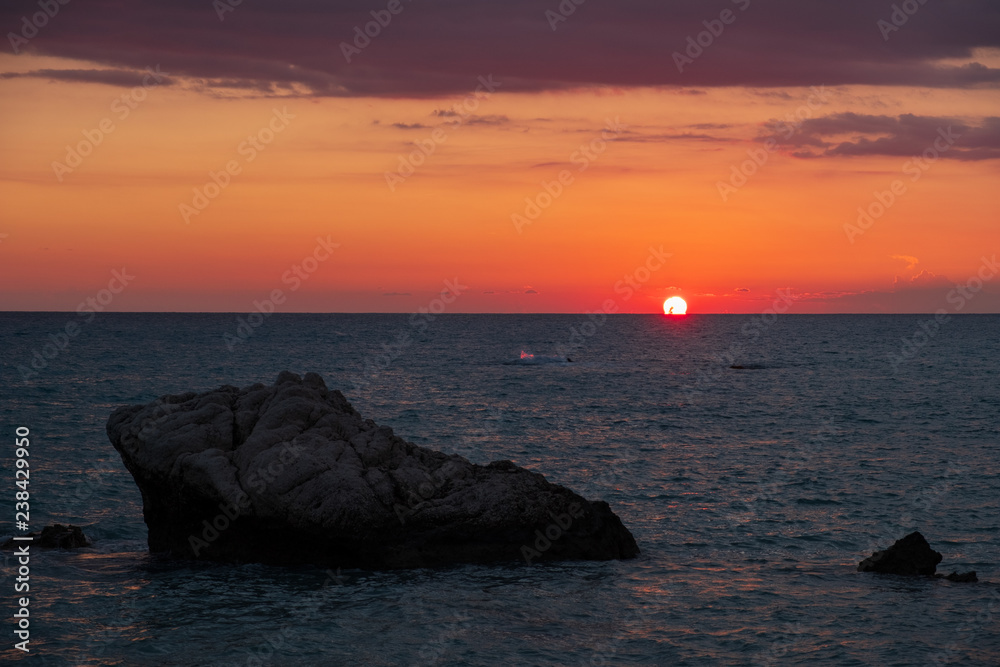 Beautiful sunset view of the beach around Petra tou Romiou, also known as Aphrodite's birthplace, in Paphos, Cyprus.