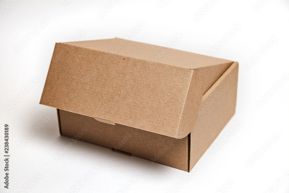 close-up single carton box open empty isolated on white background, brown parcel cardboard box for packages delivery