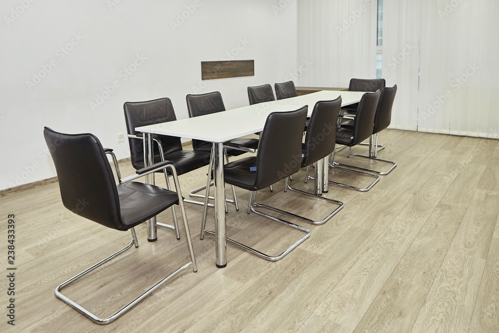 Conference negotiation room table with several leather chairs Conference negotiation room table with several leather chairs
