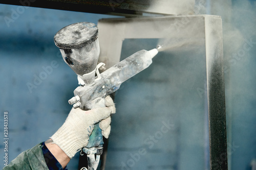 A man produces powder paint metal products.