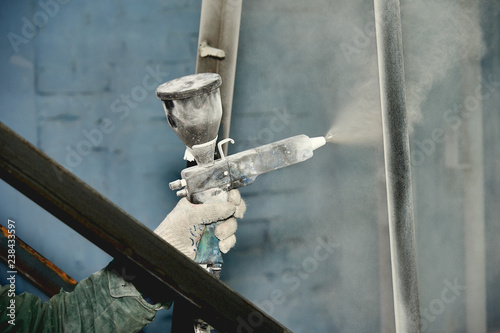 A man produces powder paint metal products.