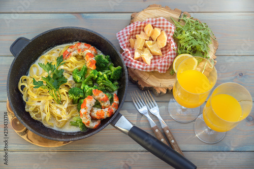 Whole grain pasta with shrimps and cheese on wooden table, top view