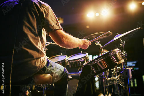 man from behind playing drums at concert