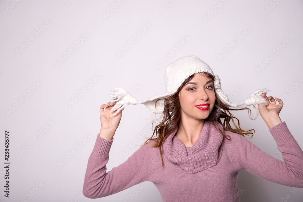 Pretty girl is wearing warm winter clothes.Young hipster girl looking happy and excited, having fun.Charming girl wears cute winter hat.Photo of good-looking cheerful lady in knitted clothes.Copy Pretty girl is wearing warm winter clothes.Young hipster girl looking happy and excited, having fun.Charming girl wears cute winter hat.Photo of good-looking cheerful lady in knitted clothes.Copy