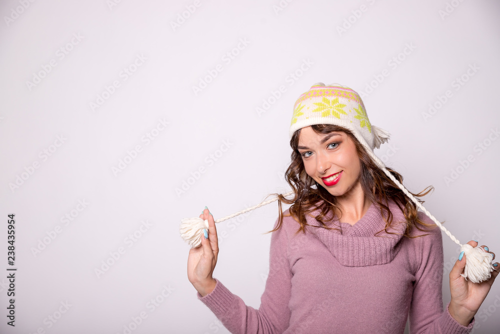Beautiful woman winter portrait. Smiling girl wearing warm clothes. Fun, kiss,positive emotions concept.Copy space. Winter shopping,Sale.Winter woman wearing warm winter clothing, sweater and wool cap