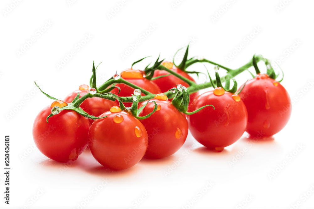 Bunch of fresh red cherry tomatoes with water drops isolated on white Bunch of fresh red cherry tomatoes with water drops isolated on white
