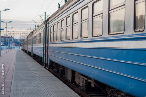blue train cars are at the station, linear perspective © Yekatseryna