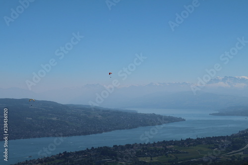 paragliding over view of river and mountains