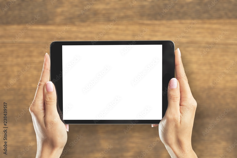 Woman holding   digital tablet on background