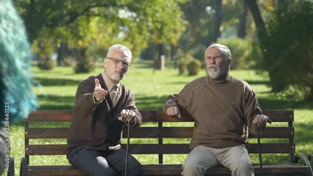 Elderly friends condemning young female outfit, unsatisfied people in old age