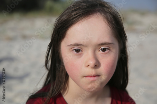 Portrait of down syndrome girl outside