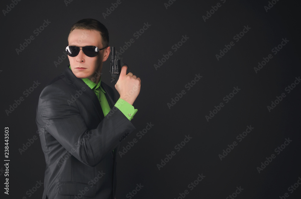 Security agent man with a gun isolated on black background. Security agent man with a gun isolated on black background.