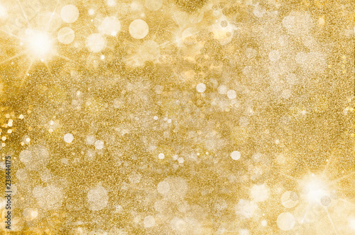 Gold glitter background. Golden bright, warm light flares and mist