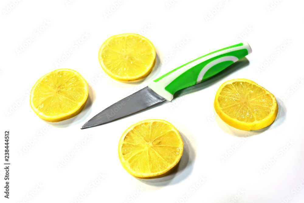sliced lemon and fruit knife on a white background. sliced lemon and fruit knife on a white background.