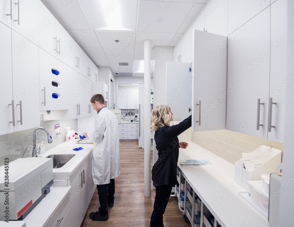 Dentist and assistant in sterilization room Dentist and assistant in sterilization room