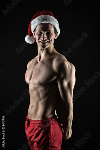 Athlete man wear santa hat. If you were bad girl. Handsome santa concept. Macho muscular torso posing confidently. Santa claus for adult girls. Sexy athletic macho muscular chest in santa claus hat © be free