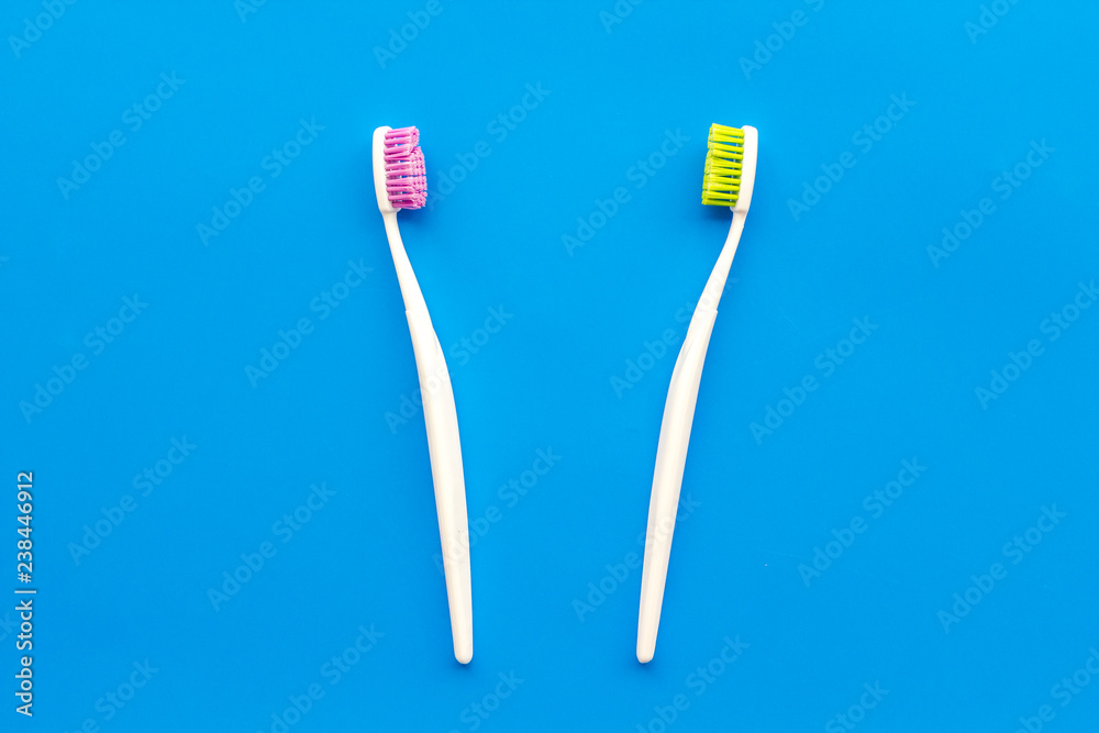 Tooth care with toothbrush. Set of cleaning products for teeth on blue background top view copy space Tooth care with toothbrush. Set of cleaning products for teeth on blue background top view copy space
