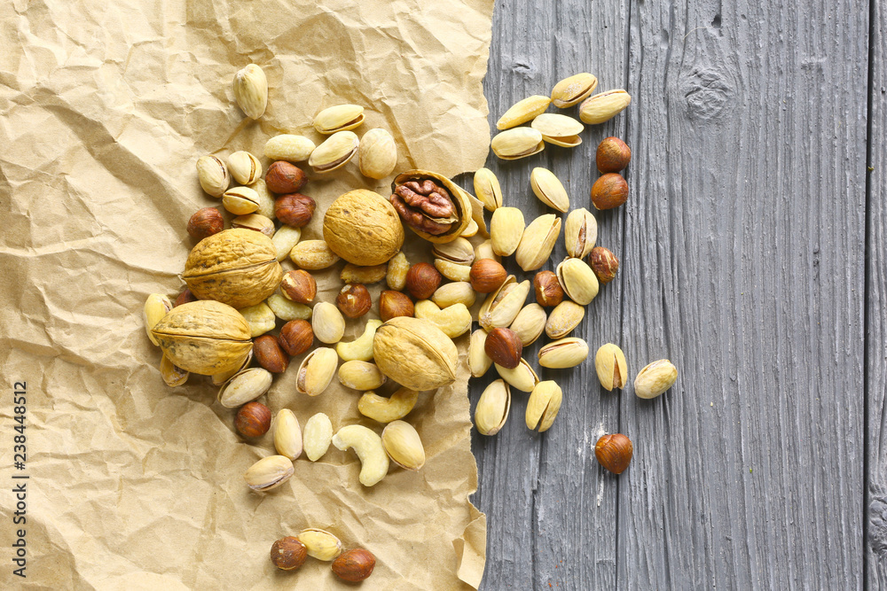 Assortment of nuts on a dark wooden table. View from above