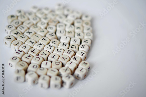 Fotografi Wooden cubes with letters of the English alphabet lie on a white background