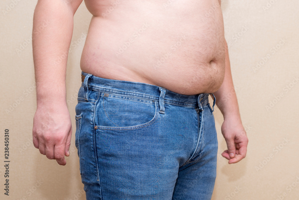 Man wearing jeans, fat belly closeup, the problem of overweight Stock Photo  | Adobe Stock