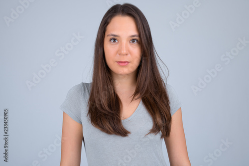 Young beautiful multi-ethnic woman against white background