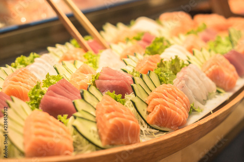 Large portion of salmon, whitefish and tuna sashimis with same cucumber