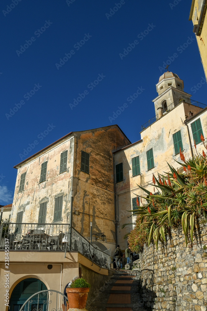 View of a medieval sea village with tourists in summer, Cervo Ligure, Liguria, Italy