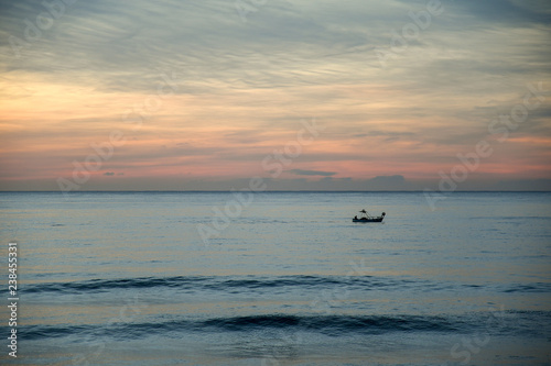 Fishing boat on the Mediterranean Sea at sunset, Alassio, Liguria, Italy