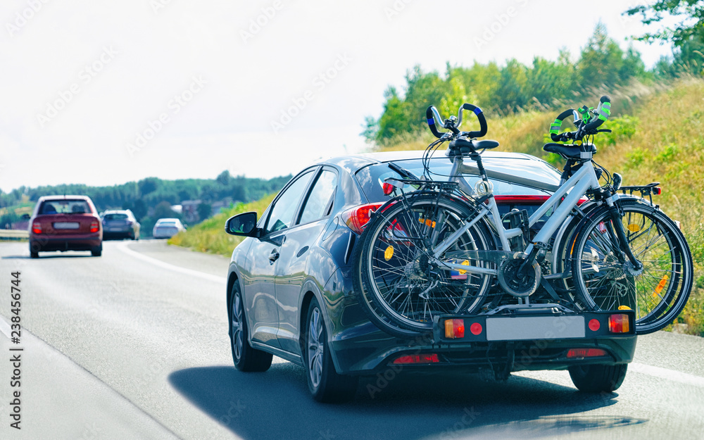 Car with bicycles in road in Poland concept Car with bicycles in road in Poland concept