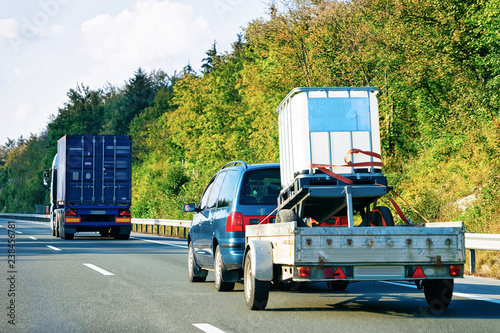 Bilde på lerret Car carrying trailer at asphalt road in Slovenia